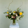 Beautiful Spring vase arrangement, with yellow roses, blue delphinium, white lisianthus, pink