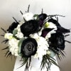 Black and white floral arrangement in a white vase
