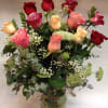 Bouquet of red and pink roses in a glass vase