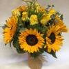 Bouquet of yellow roses and sunflowers in a burlap-wrapped vase