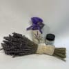 Bundle of dried lavender with a small candle jar and sachet