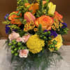 Bright mixed bouquet with orange and yellow roses and pink blooms