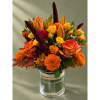 Orange and yellow mixed bouquet in a clear glass vase