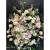 Large pastel floral spray with roses, calla lilies, hydrangeas, and orchids