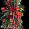 Large tropical floral arrangement with red anthuriums and orange gerbera daisies
