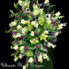 Tall floral spray with green orchids, purple blooms, and white flowers