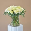 White roses arranged in a clear glass vase