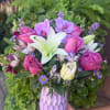 Pink roses and white lilies in a lavender vase