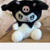 Plush black-and-white character stuffed animal sitting on a table