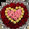 Heart-shaped bouquet of red and pink roses with gold chocolates