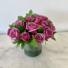 Pink roses arranged in a clear glass vase