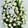 White rose and lily standing spray with a ribbon bow