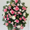 Standing floral spray with pink roses, lilies, and white chrysanthemums