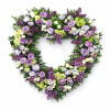 Heart-shaped floral wreath with purple, white, and green flowers