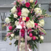 Large standing floral spray with pink and white flowers on an easel