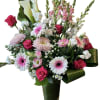 Mixed bouquet with pink roses, gerbera daisies, calla lilies, and snapdragons in a vase