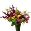 Mixed bouquet with pink roses, yellow calla lilies, and magenta flowers in a glass vase