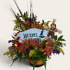 Halloween floral arrangement with a witch sign and scarecrow decoration