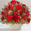 Red roses and lilies in a decorative white container