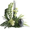 Green floral arrangement with a dark urn vase