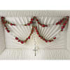 White funeral casket with red rose garlands and a small cross