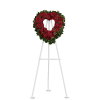 Heart-shaped red rose wreath on a white easel stand