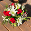 - 3 Stems White Lilies
- 8 Red Roses
- Baby Breath
- Pine Cones
-