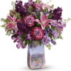 Pink and purple mixed bouquet in a tall iridescent vase