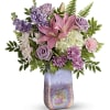 Pink lilies and lavender roses in a tall iridescent vase