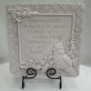 Decorative plaque with a cardinal and floral relief around a sympathy message