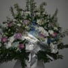 Large sympathy spray with pink roses, white daisies, and blue flowers