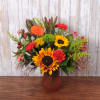 Mixed bouquet with sunflowers, gerbera daisies, and carnations in a vase