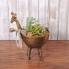 Succulent arrangement in a bronze animal-shaped planter with a ribbon bow