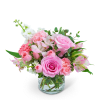 Pink roses and carnations in a clear glass vase