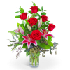 Red roses and pink lilies in a clear glass vase