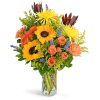 Mixed bouquet of sunflowers, orange roses, and a clear glass vase