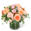Peach and pink roses with carnations in a glass vase