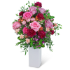 Pink and burgundy floral arrangement in a white vase
