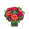 Bouquet of orange and pink roses in a glass vase