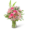 Pink roses and carnations in a clear glass vase