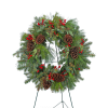 Evergreen wreath with pinecones and red berries on a stand