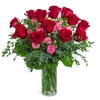 Red and pink roses in a clear glass vase
