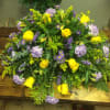 Large bouquet of yellow roses and lavender flowers on a wooden table