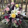Bouquet with white lilies, yellow and pink roses, and purple flowers