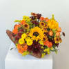 Basket arrangement of sunflowers, orange roses, and burgundy mums