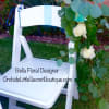 White chair decorated with eucalyptus and white roses
