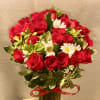 Bouquet of red roses and white daisies in a glass vase
