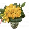 Yellow roses and lilies arranged in a glass vase