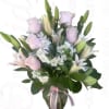 Bouquet of pink roses and white lilies in a glass vase