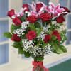 Bouquet of red roses and pink lilies in a glass vase